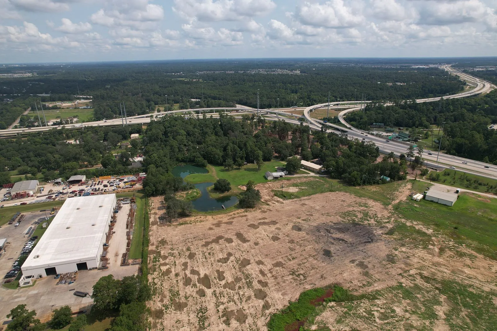 Drone aerial of a development tract with highway frontage in north Houston