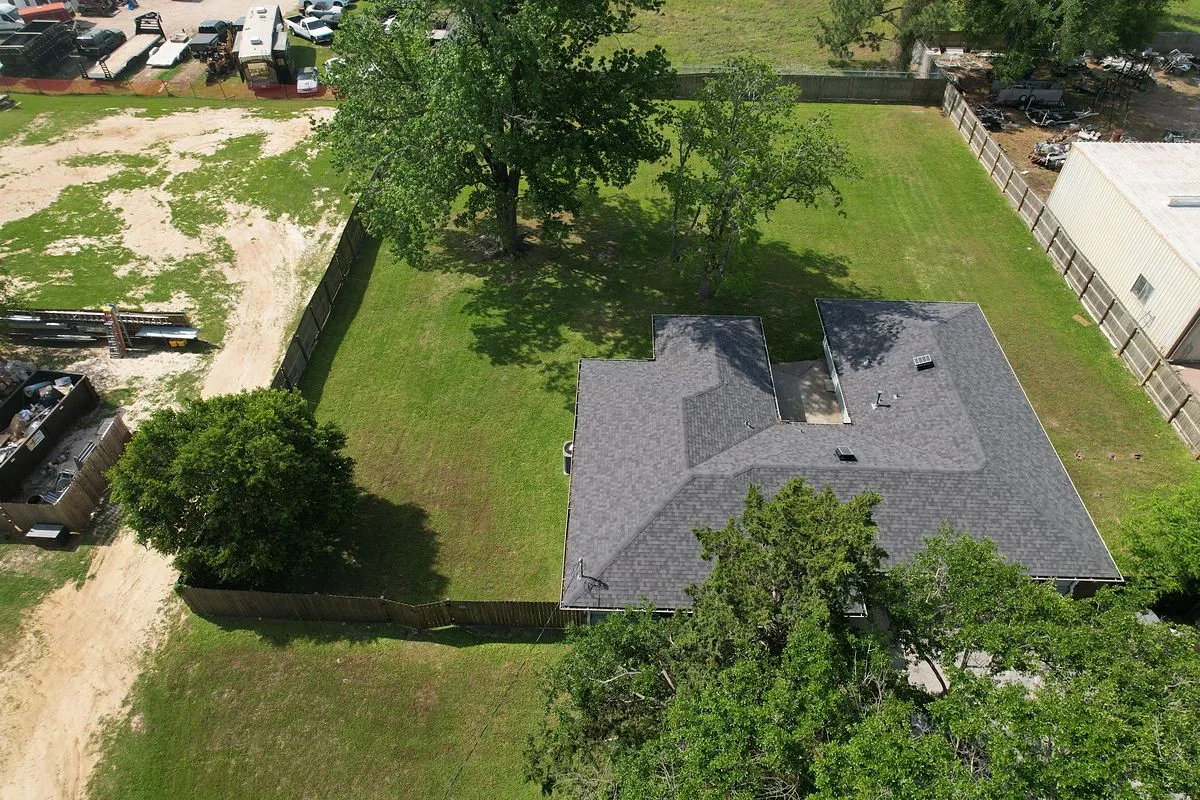 Drone aerial of a converted home on a large fenced lot in Katy, Texas