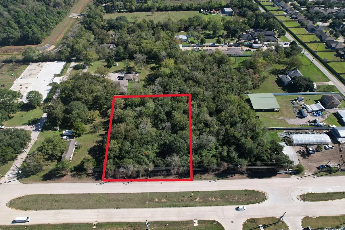 Drone aerial of a wooded lot in Tomball, Texas, outlined in red